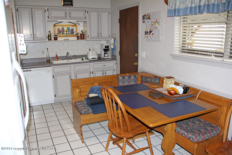 5210 South Travis Street Amarillo, TX 79110 - Photo 8 of 29 a kitchen with stainless steel appliances kitchen island granite countertop a sink and a refrigerator