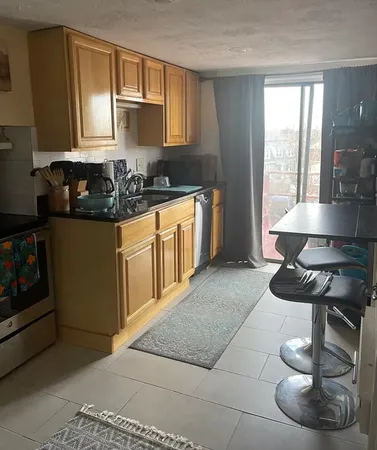 a kitchen with stainless steel appliances granite countertop a sink and a stove