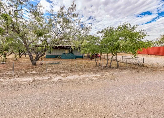 a view of a yard with a tree