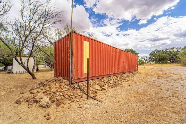 a backyard of a house with large trees