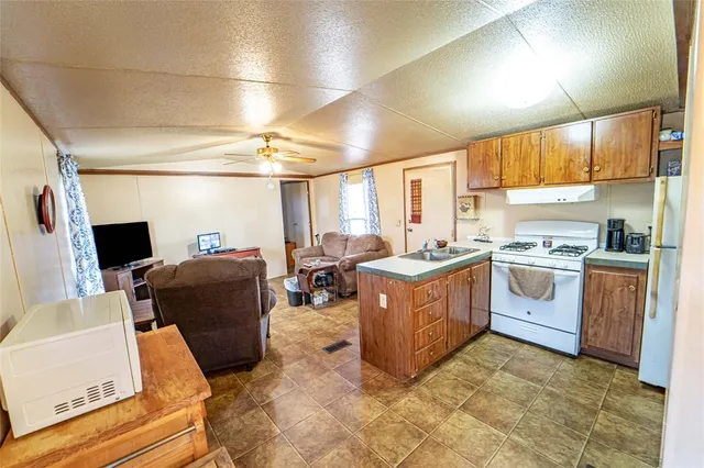 a kitchen with sink cabinets and appliances