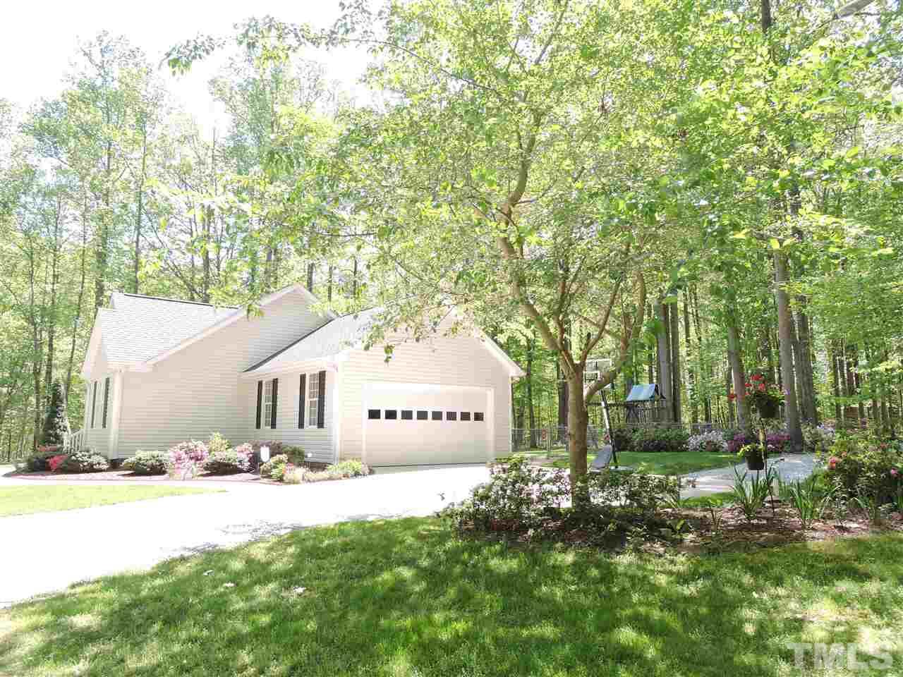 3337 Cates Mill Road Roxboro, NC 27574 - Photo 2 of 25 a front view of a house with garden