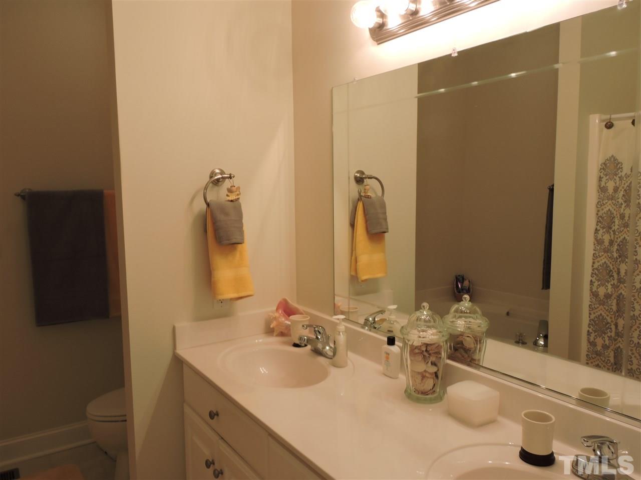3337 Cates Mill Road Roxboro, NC 27574 - Photo 13 of 25 a bathroom with a sink and a mirror