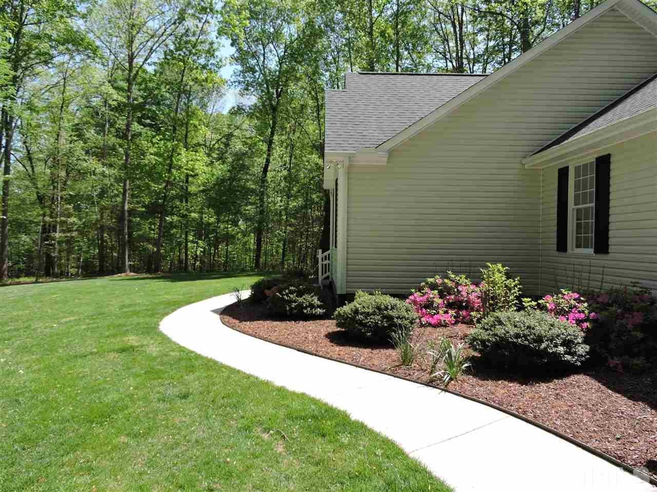 3337 Cates Mill Road Roxboro, NC 27574 - Photo 20 of 25 a view of a garden with flowers and flowers