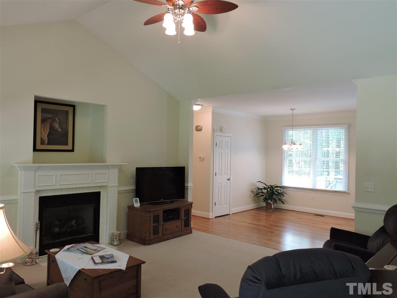 3337 Cates Mill Road Roxboro, NC 27574 - Photo 3 of 25 a living room with furniture a flat screen tv and a fireplace