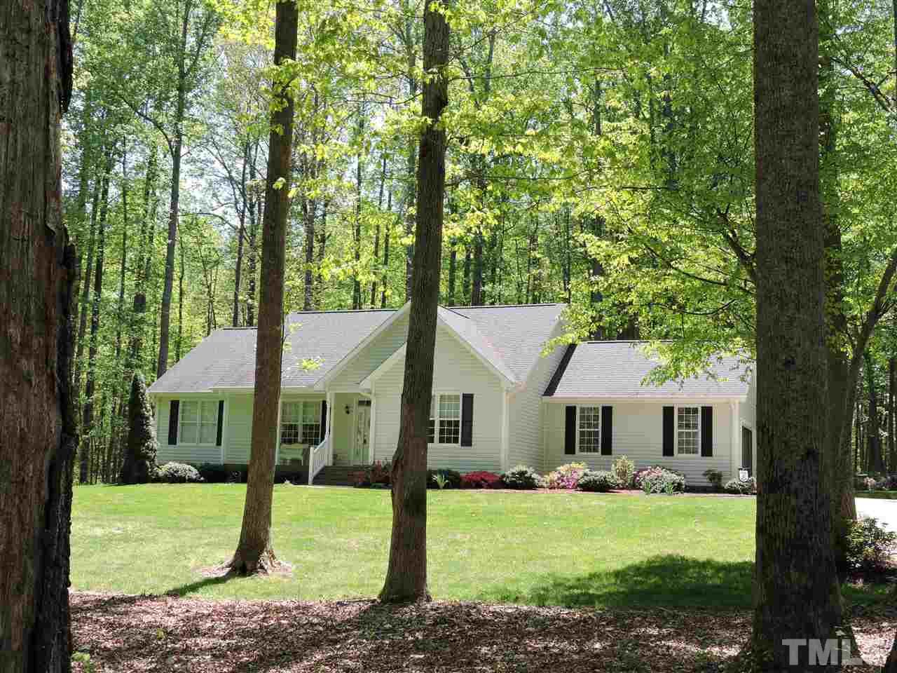 3337 Cates Mill Road Roxboro, NC 27574 - Photo 23 of 25 a front view of a house with a garden