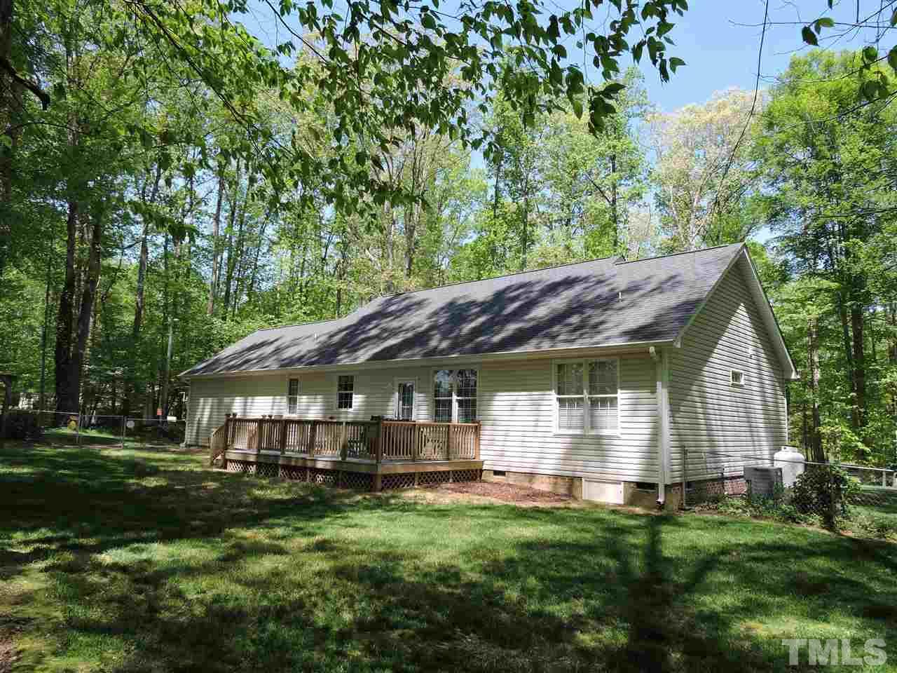3337 Cates Mill Road Roxboro, NC 27574 - Photo 25 of 25 a front view of a house with a garden