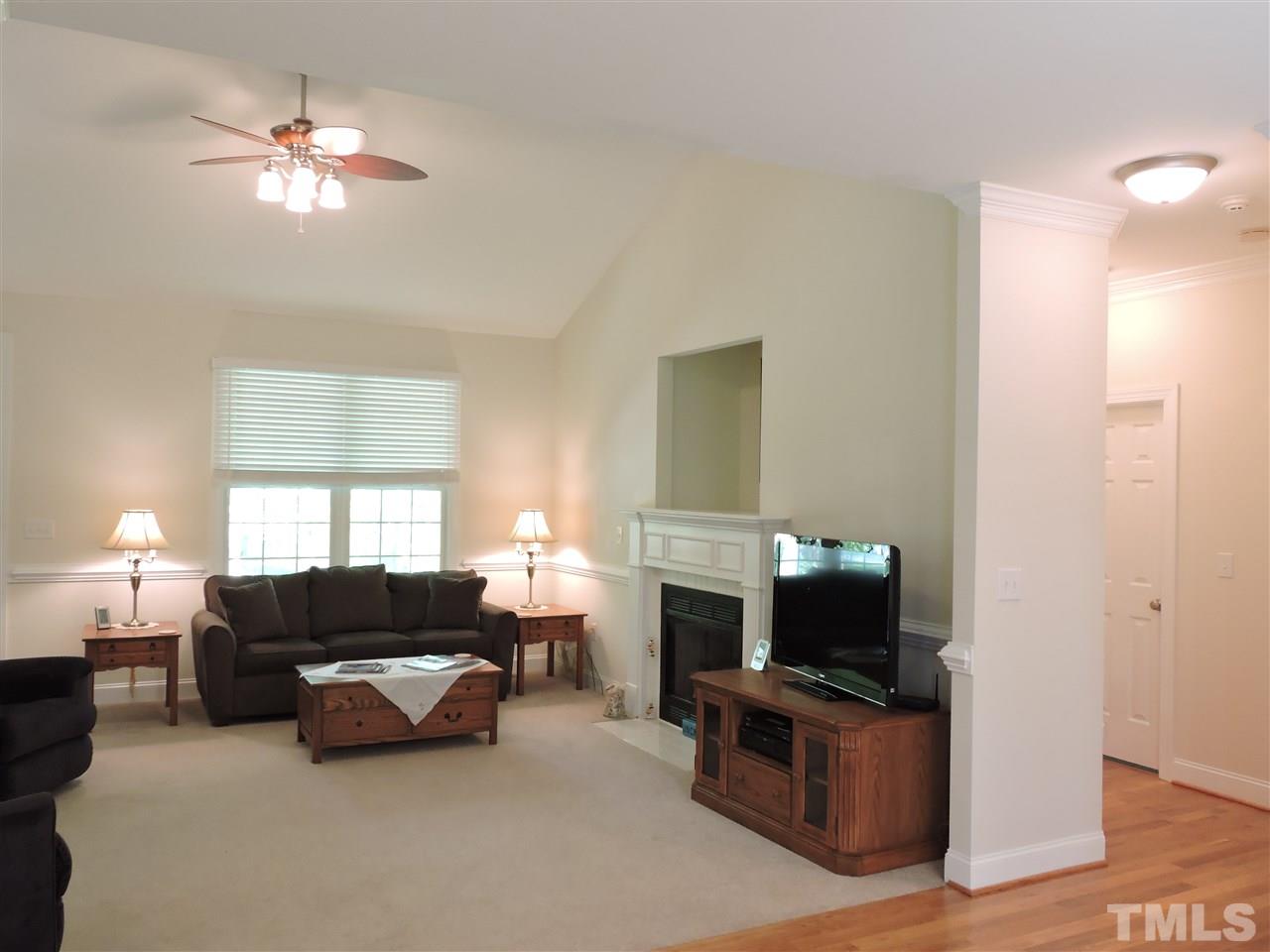3337 Cates Mill Road Roxboro, NC 27574 - Photo 8 of 25 a living room with furniture a fireplace and a chandelier