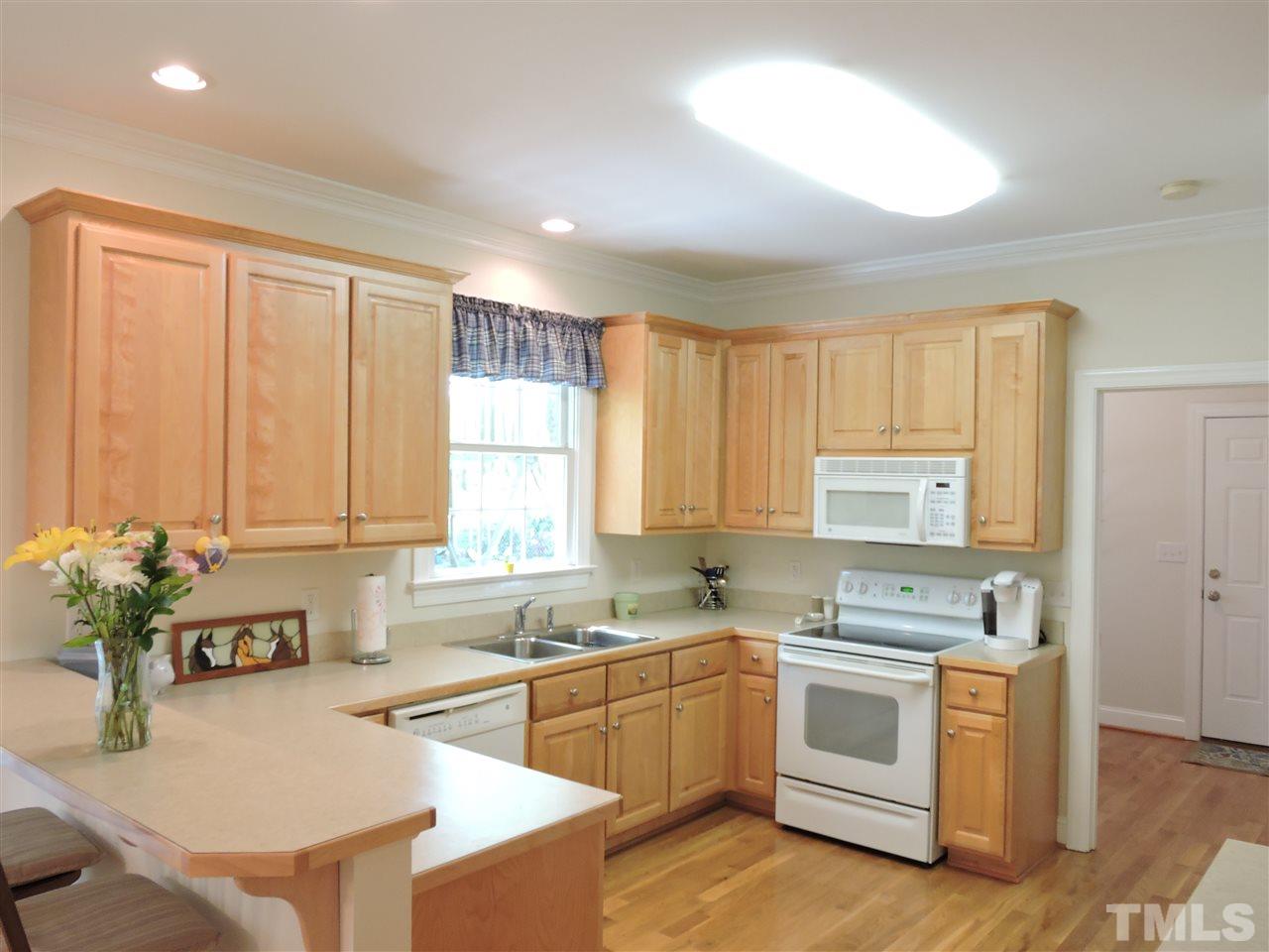 3337 Cates Mill Road Roxboro, NC 27574 - Photo 9 of 25 a kitchen with a white stove top oven and white cabinets