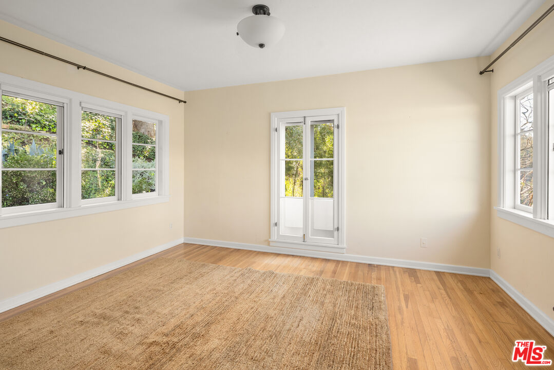 35 Haldeman Road Santa Monica, CA 90402 - Photo 11 of 18 an empty room with wooden floor and windows