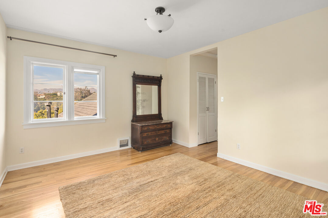 35 Haldeman Road Santa Monica, CA 90402 - Photo 12 of 18 a view of empty room with wooden floor and fan
