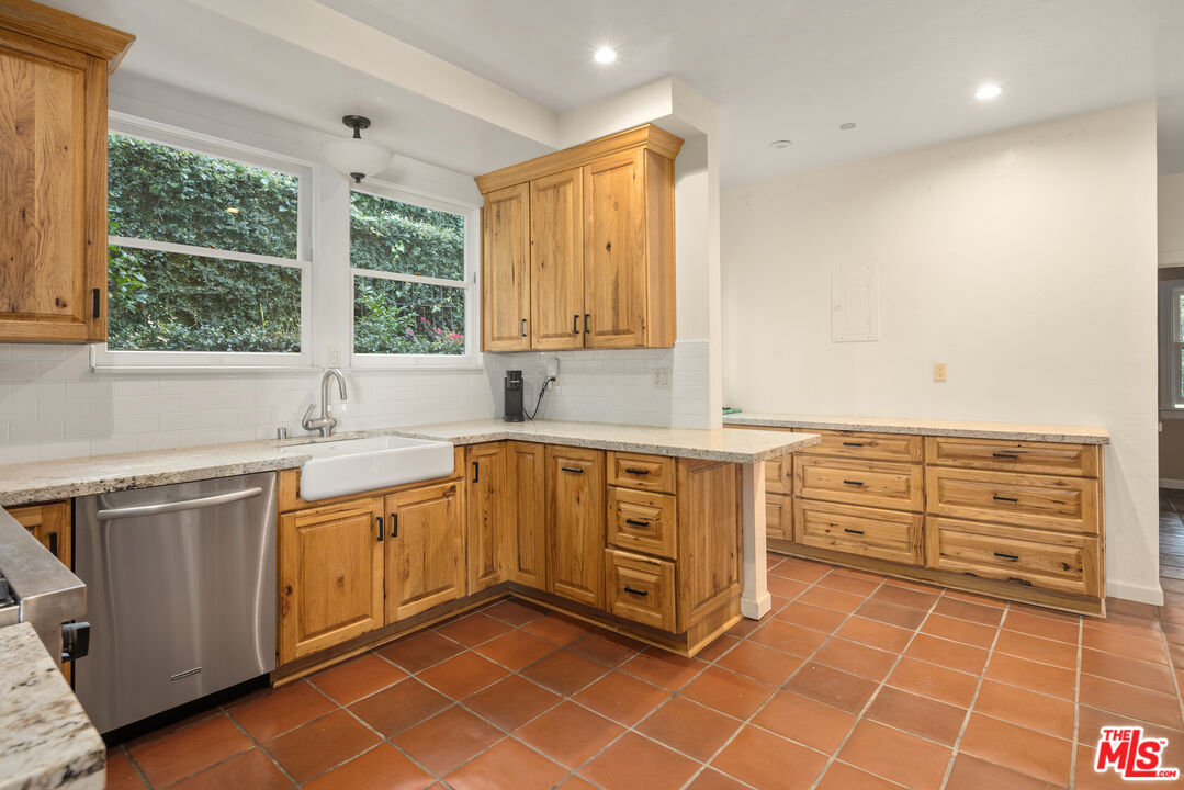 35 Haldeman Road Santa Monica, CA 90402 - Photo 7 of 18 a kitchen with stainless steel appliances granite countertop a stove a sink and a microwave