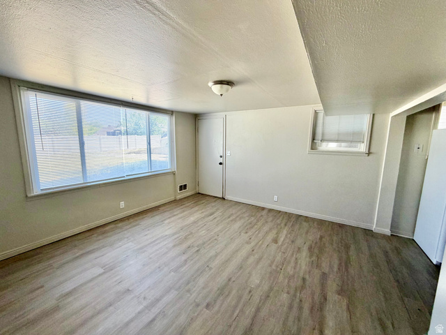 7 Foothill Boulevard Pocatello, ID 83204 - Photo 3 of 13 Room featuring wood-finish flooring, light-toned wall paint, and white trim
