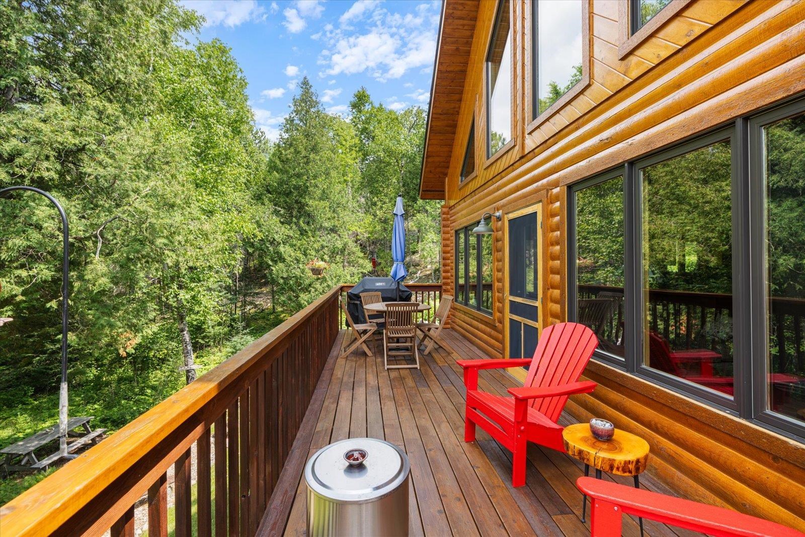 540 Loop Road Ely, MN 55731 - Photo 13 of 20 Wooden terrace featuring outdoor dining space and view of wooded area