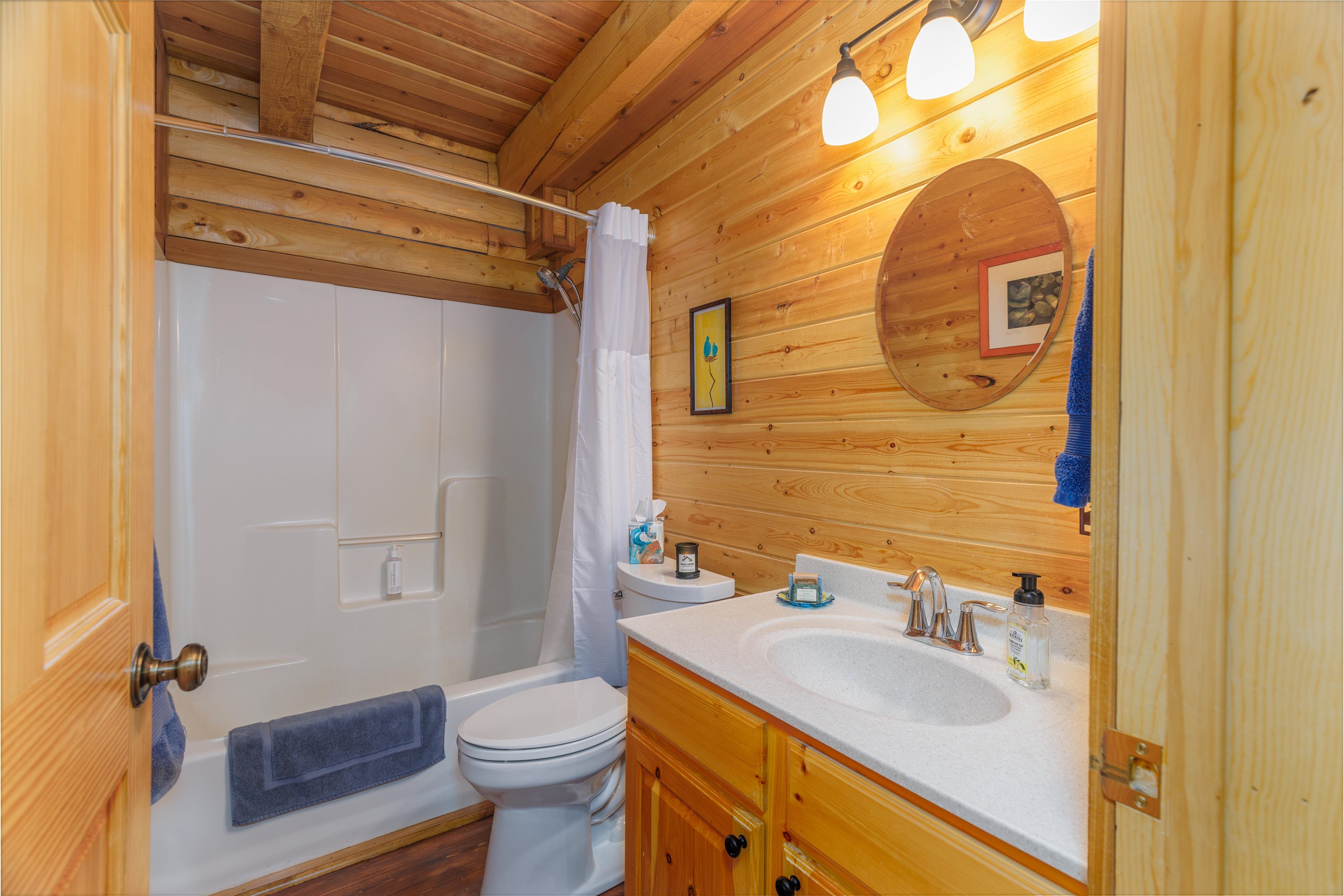540 Loop Road Ely, MN 55731 - Photo 6 of 20 Bathroom with shower / tub combo, vanity, wood walls, and wooden ceiling