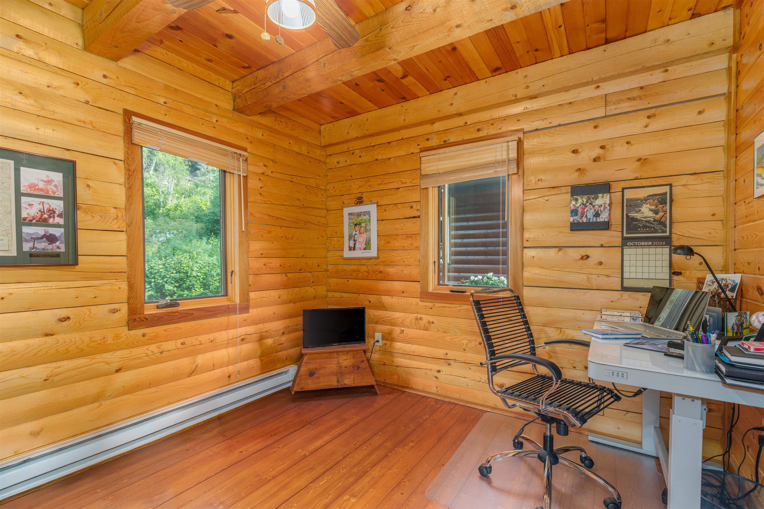 540 Loop Road Ely, MN 55731 - Photo 7 of 20 Office area featuring a wooden ceiling with exposed beams, a baseboard heating unit, rustic walls, and wood-type flooring