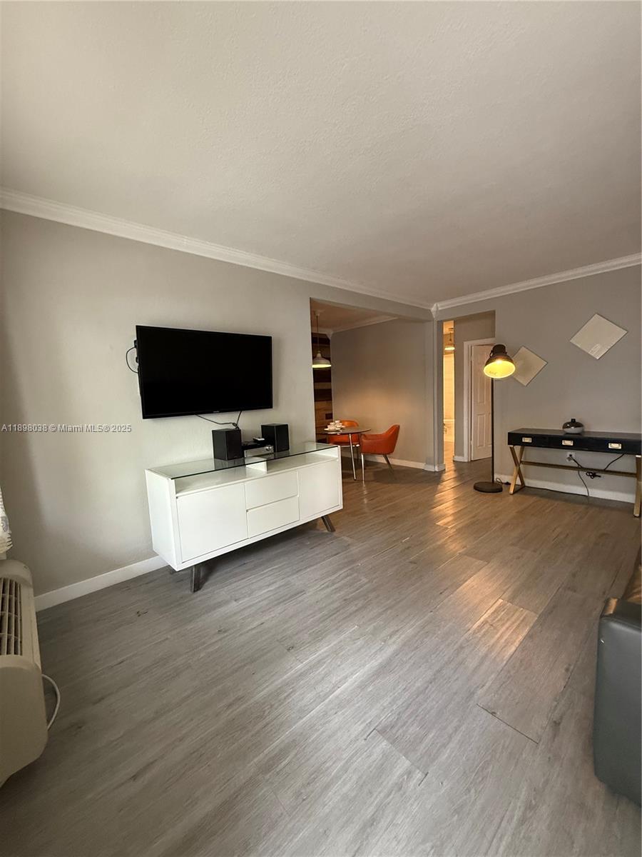 7710 Harding Avenue, Unit 1 Miami Beach, FL 33141 - Photo 10 of 14 a view of a livingroom with furniture and a flat screen tv
