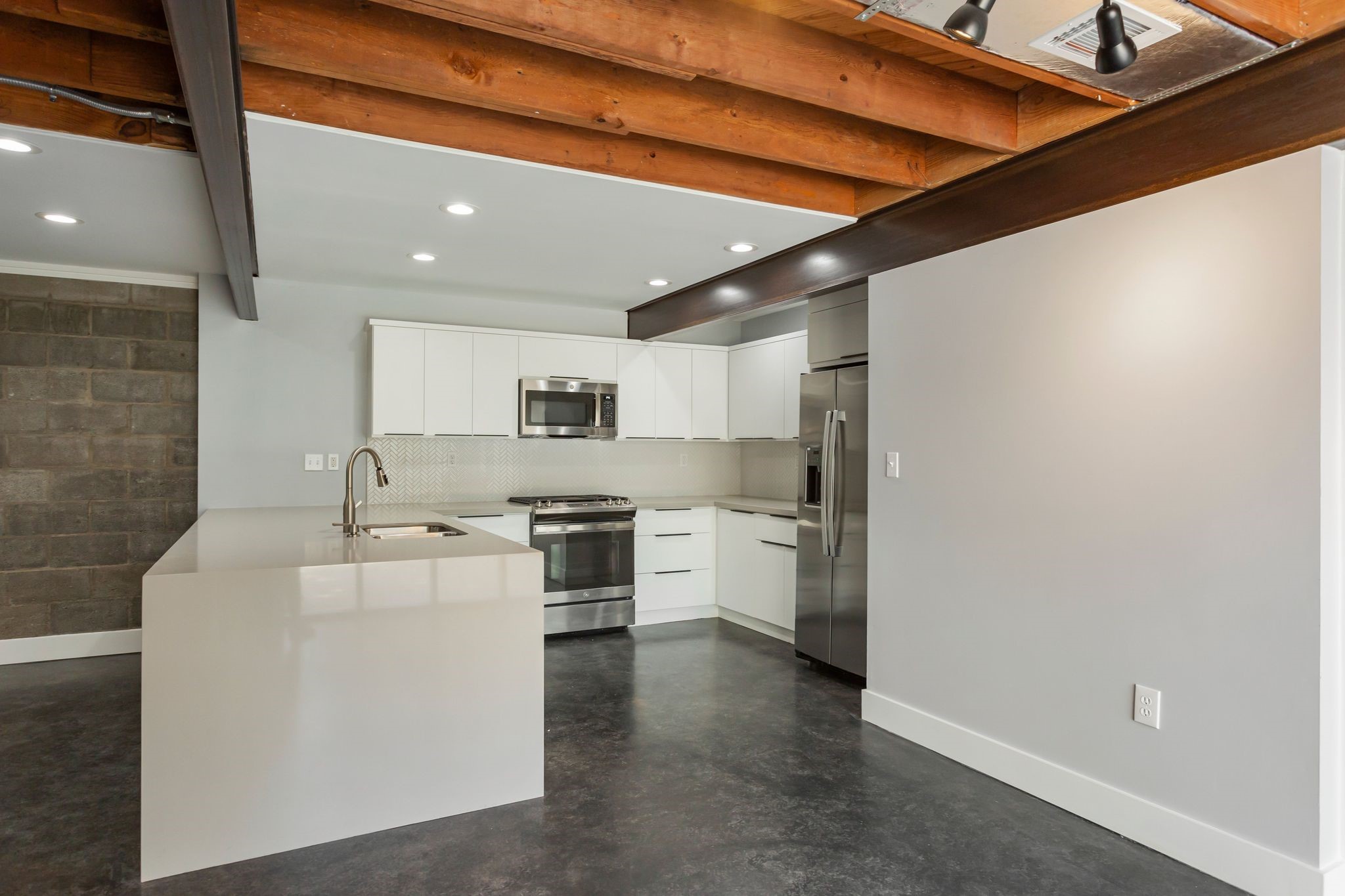 2005 Portsmouth Street, Unit C Houston, TX 77098 - Photo 13 of 26 a kitchen with stainless steel appliances a sink stove and refrigerator