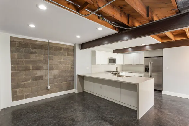 a kitchen with white cabinets and white appliances