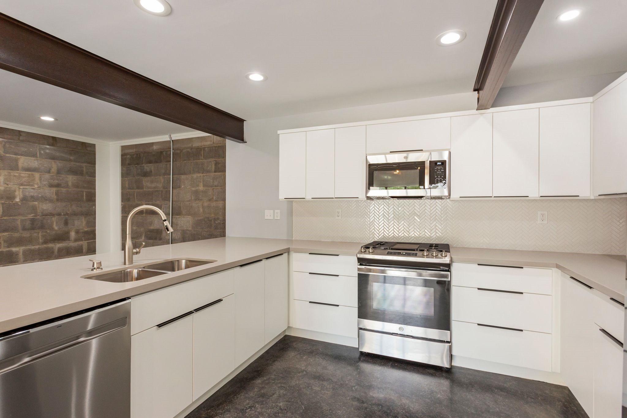 2005 Portsmouth Street, Unit C Houston, TX 77098 - Photo 8 of 26 a kitchen with white cabinets stainless steel appliances and sink