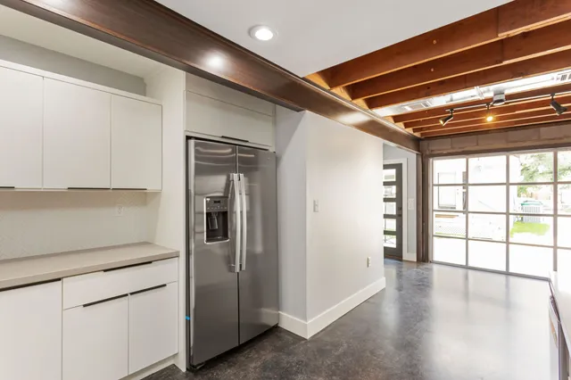 a kitchen with sink and cabinets