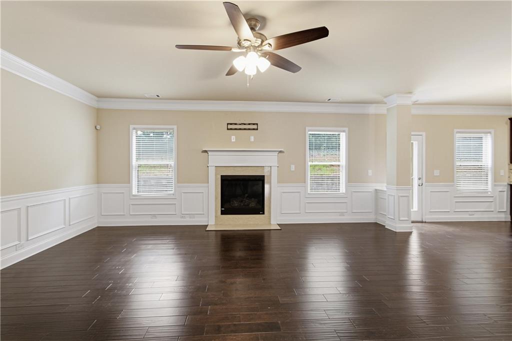 114 Madison Street Canton, GA 30115 - Photo 9 of 39 a view of an empty room with wooden floor and a window