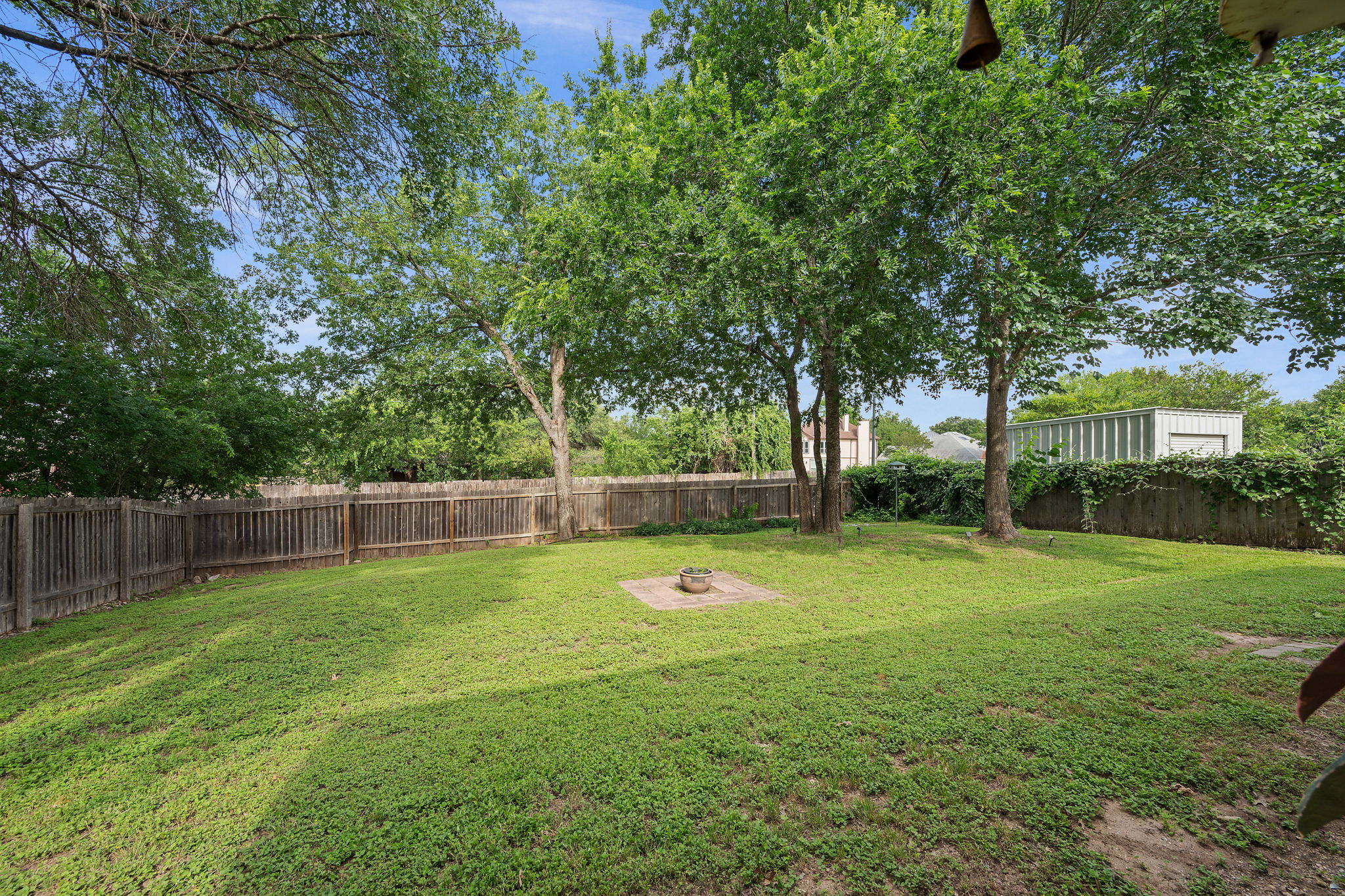 705 Canyon Bend Road Pflugerville, TX 78660 - Photo 22 of 23 a swimming pool with lots of green space and trees in the background