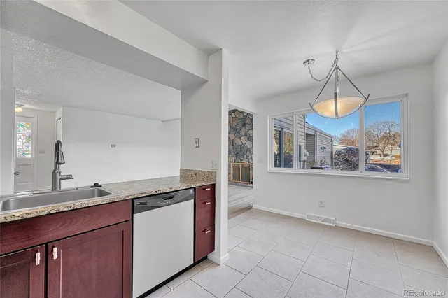a kitchen with stainless steel appliances granite countertop a sink and cabinets