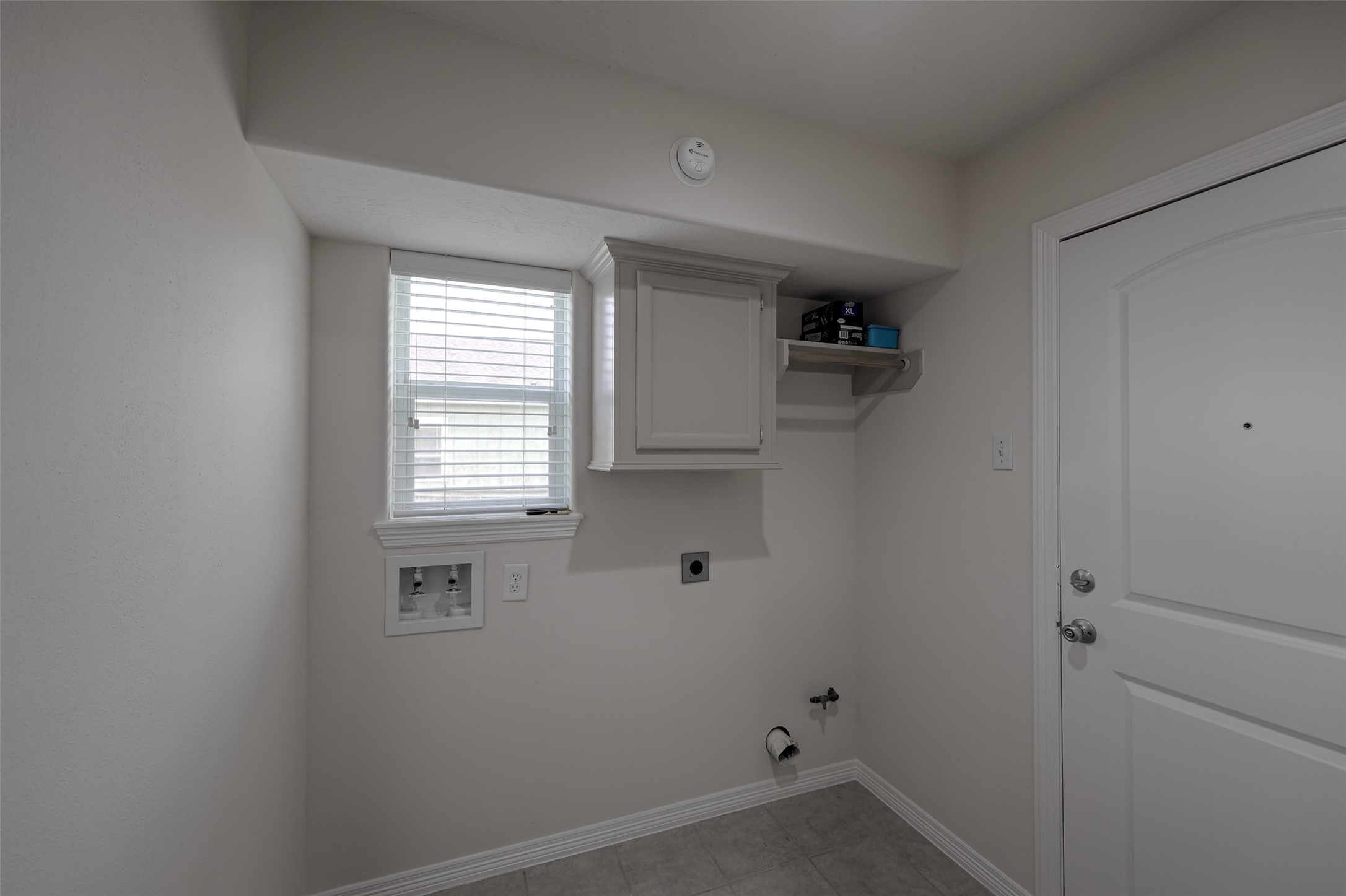 14605 Ophiuchus Court Willis, TX 77318 - Photo 22 of 37 Laundry room with direct access to the garage.