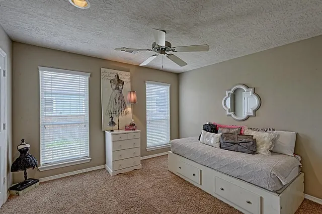 a bedroom with bed and a window