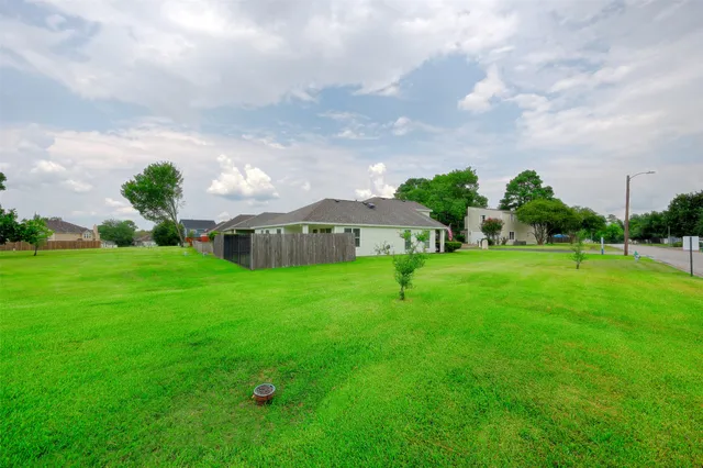a view of an house with backyard space and garden