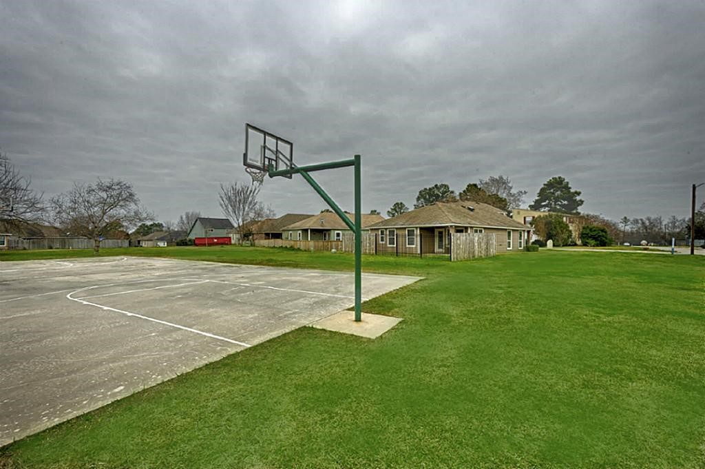14605 Ophiuchus Court Willis, TX 77318 - Photo 34 of 37 Basketball court and green space near the home.