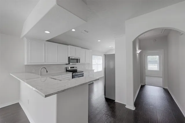 a kitchen with sink and cabinets