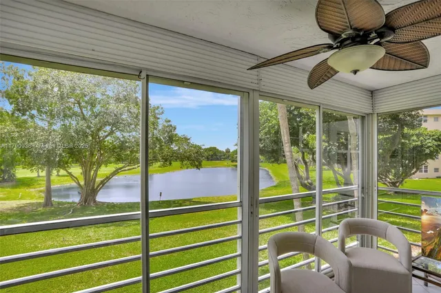 a view of a porch with furniture and a yard