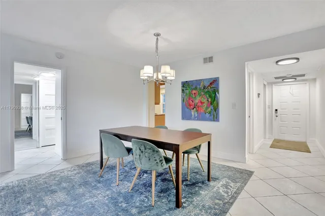 a living room with furniture a flat screen tv and a floor to ceiling window