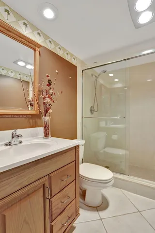 a white toilet sitting next to a bathroom sink