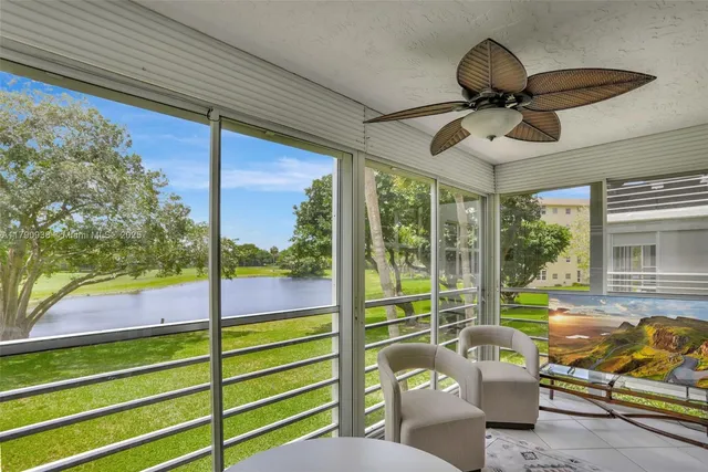 a living room with furniture and a floor to ceiling window