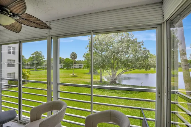 a view of a livingroom with furniture and a large window