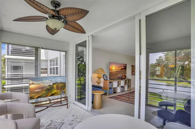 a view of a porch with furniture and a backyard