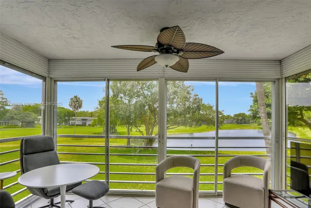 a front view of a building with a garden and plants