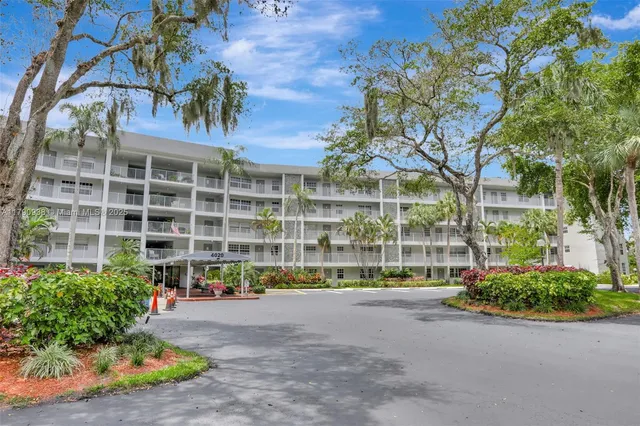 a view of a swimming pool with an outdoor seating and a yard