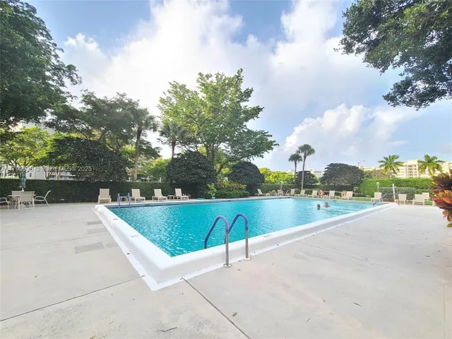 a view of a patio with table and chairs and potted plants