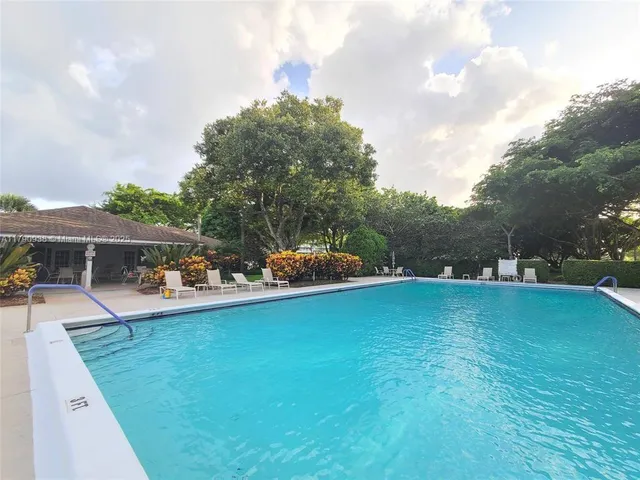 a dining room with furniture a floor to ceiling window and a ceiling fan
