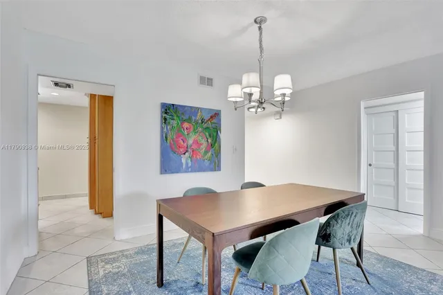 a view of a dining room with furniture wooden floor and a chandelier