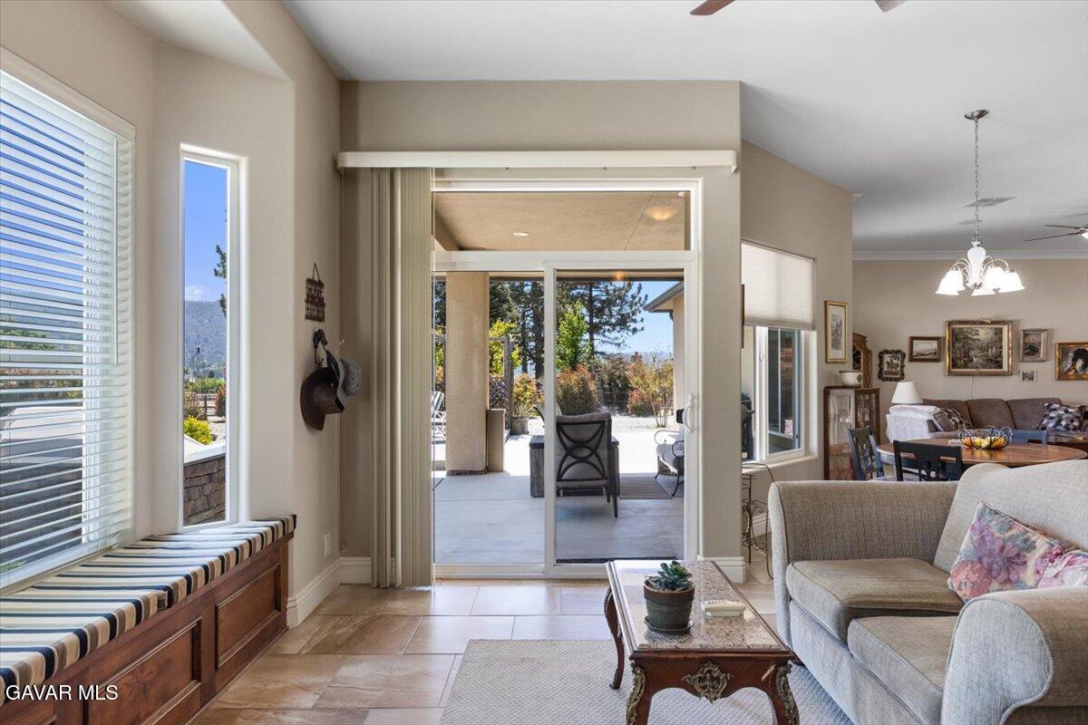 23840 Martingale Way Tehachapi, CA 93561 - Photo 38 of 63 a living room with furniture and a dining table next to a window