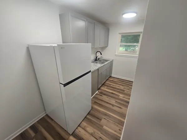 a view of an entryway with wooden floor