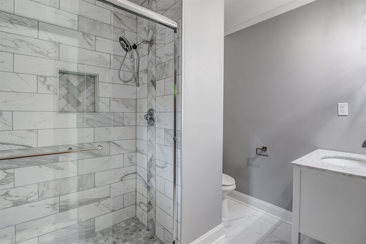 5209 South Angela Road Memphis, TN 38117 - Photo 15 of 25 Second master bath features a shower with marble flooring.