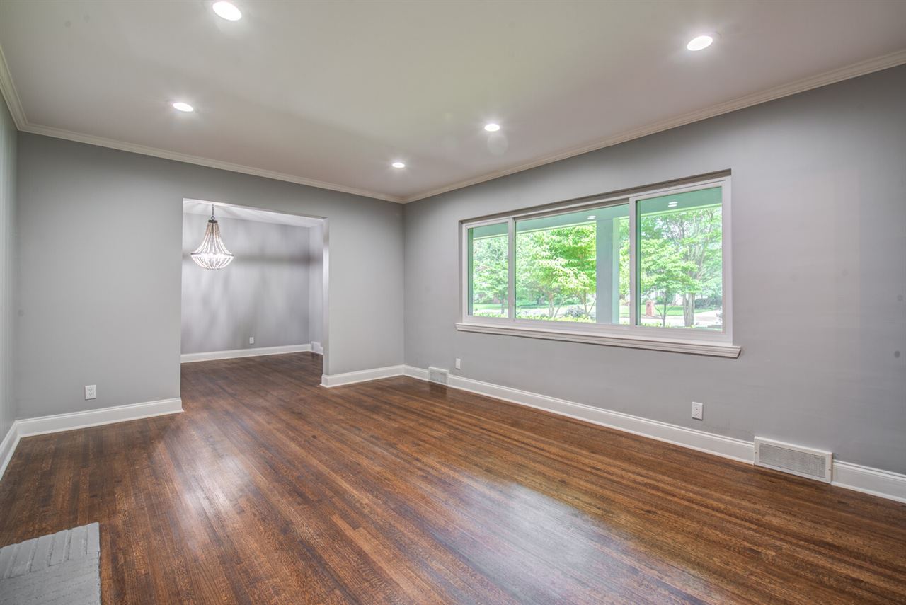 Nice formal living room with big bright windows and a wood burning fireplace