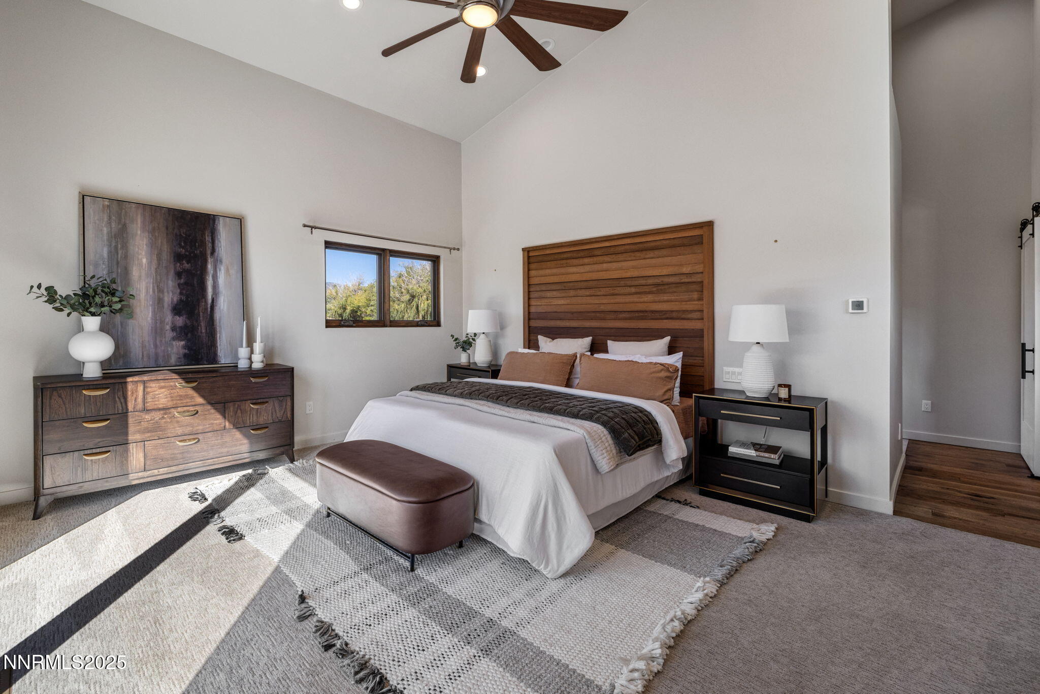 2255 Warrior Lane Reno, NV 89523 - Photo 11 of 52 a bedroom with a bed a couch and a chandelier