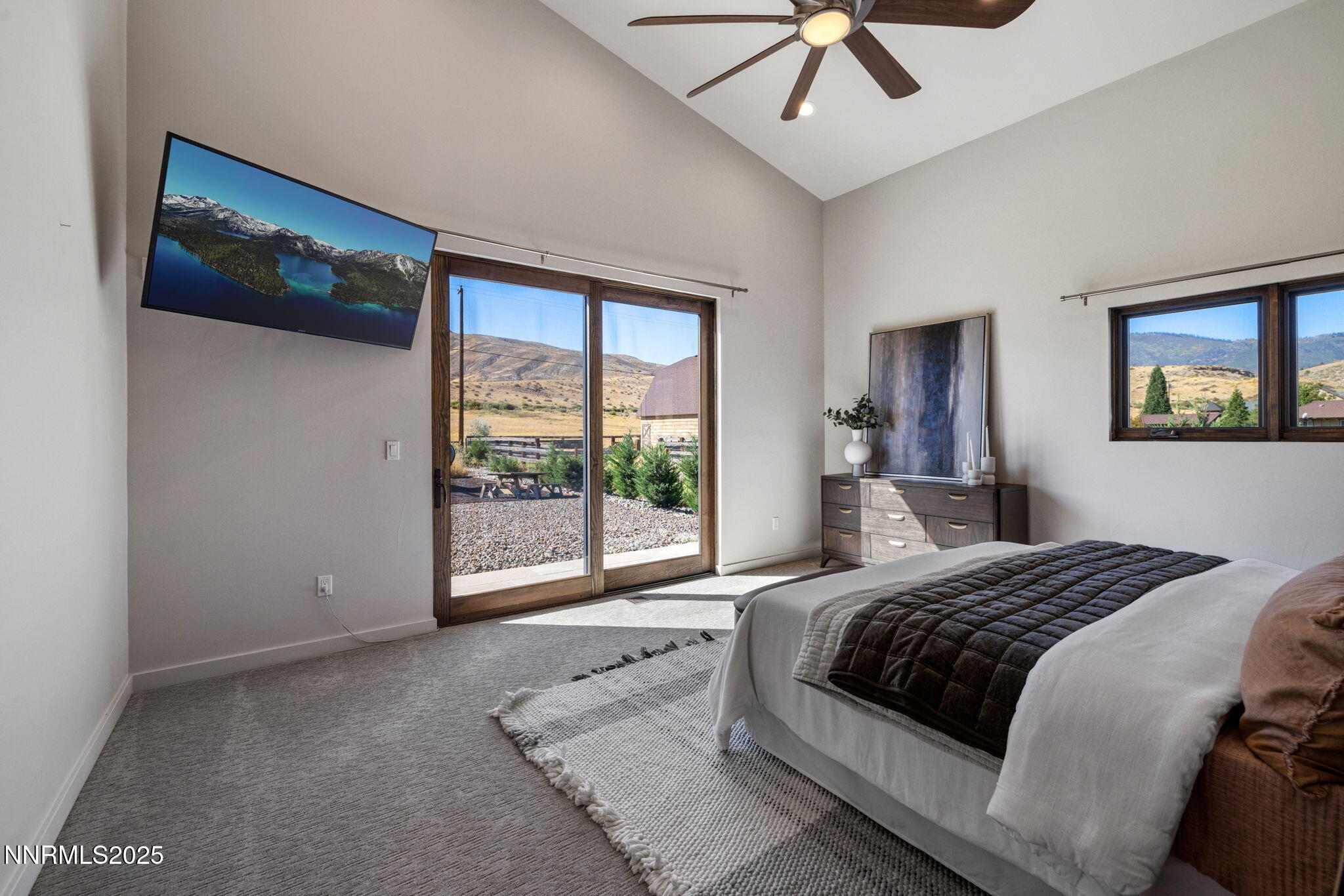 2255 Warrior Lane Reno, NV 89523 - Photo 12 of 52 a bedroom with a large bed and a flat tv screen on dresser